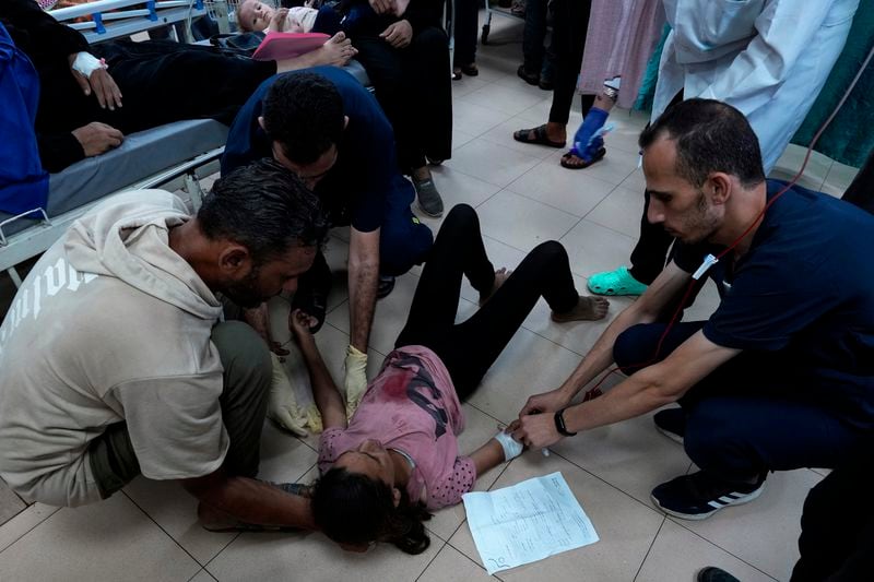 Palestinian medics treat a wounded girl in an Israeli bombardment of Nuseirat refugee camp, at the al-Aqsa Martyrs Hospital in Deir al Balah, central Gaza Strip, late Thursday, June 27, 2024. (AP Photo/Abdel Kareem Hana)