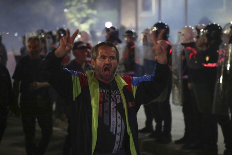 An opposition supporter protests during a rally, in Tirana, Albania, Monday, Oct. 7, 2024. (AP Photo/Hameraldi Agolli)