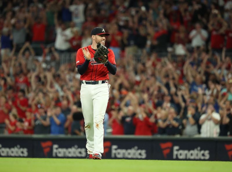 Braves first baseman Freddie Freeman celebrates. (JASON GETZ/SPECIAL TO THE AJC)