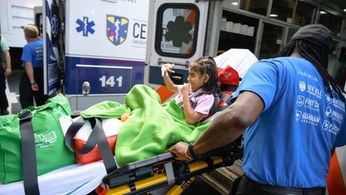 Eight-year-old Brithany Morales waves goodbye to Children's Healthcare of Atlanta's Egleston hospital.  As Egleston closed for good on Sunday, Morales was the first patient it transferred to the brand-new Arthur M. Blank Hospital at I-85 and North Druid Hills Road, which opened to patients the same time on the same day as Egleston closed, 7:00 a.m. on September 29, 2024. (Photo courtesy of Children's Healthcare of Atlanta)