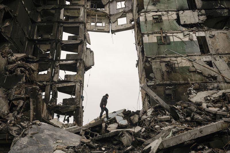 FILE - A resident looks for belongings in an apartment building destroyed during fighting between Ukrainian and Russian forces in Borodyanka, Ukraine, April 5, 2022. Charitable giving dropped 2.1% in 2023 after inflation, according to the most recent Giving USA report, the key findings of which were released Tuesday, June 25, 2024. (AP Photo/Vadim Ghirda, File)