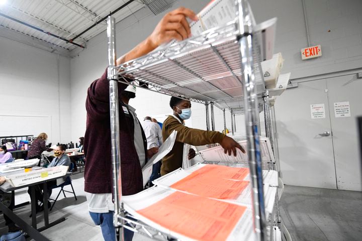 Workers sort through provisional ballots as votes for President are recounted at the Gwinnett County elections office on Friday, Nov.13, 2020 in Lawrenceville. (JOHN AMIS FOR THE ATLANTA JOURNAL-CONSTITUTION)