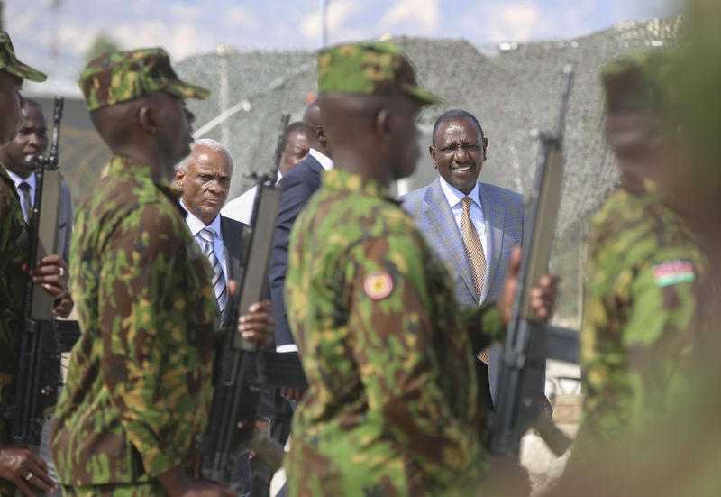 Kenya's President William Ruto, right, and Transition Council President Edgard Leblanc, arrive to the Kenyan base in Port-au-Prince, Haiti, Saturday, Sept. 21, 2024. (AP Photo/Odelyn Joseph)