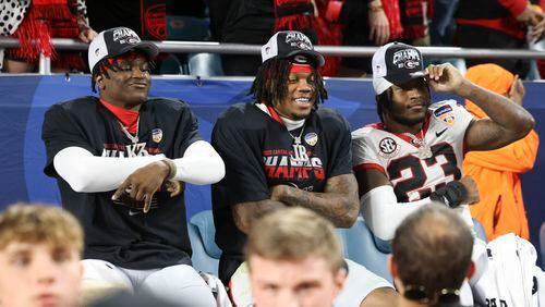 Georgia defensive backs Kamari Lassiter (3), Javon Bullard (22), and Tykee Smith (23) pose for the cameras after Georgia’s 63-3 win against Florida State in the Orange Bowl at Hard Rock Stadium, Saturday, Dec. 30, 2023, in Miami Gardens, Florida. (Jason Getz / Jason.Getz@ajc.com)