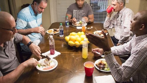 A group of members from different churches in Georgia meet for supper at participant Eddie L. Johnson’s house in Alpharetta on Monday night to participate in the “Conversations” movement, a series of joint discussions about race. Lee Jenkins, senior pastor at Eagles Nest Church in Roswell, center, leads the discussion with Stephen Gilkenson, George Dempsey, Matthew Hendley and Eddie L. Johnson, left to right. (Jenna Eason / Jenna.Eason@coxinc.com)