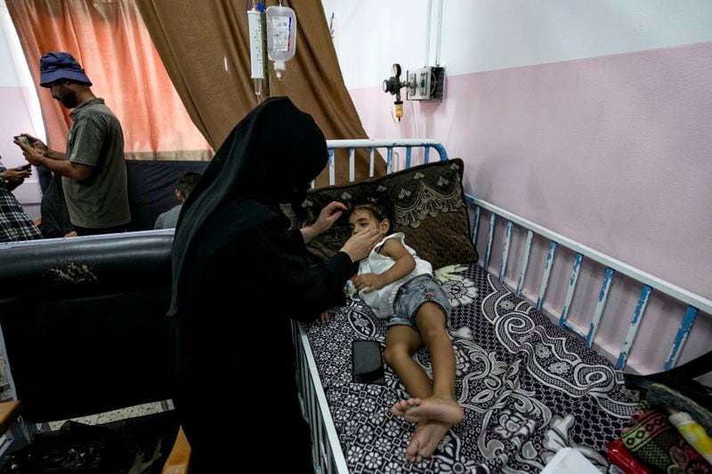 A Palestinian child waits to receive a polio vaccination at a hospital in Khan Younis, Saturday, Aug. 31, 2024. (AP Photo/Abdel Kareem Hana)