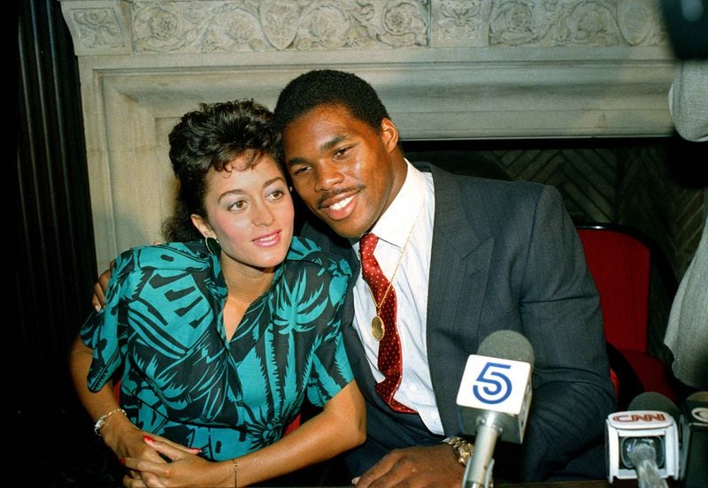 Republican U.S. Senate candidate Herschel Walker is shown in a 1986 photo with his first wife, Cindy Grossman, In a 2008 interview, Grossman described domestic abuse by Walker. “He held the gun to my temple and said he was gonna blow my brains out,” she said. (AP Photo/Marty Lederhandler)