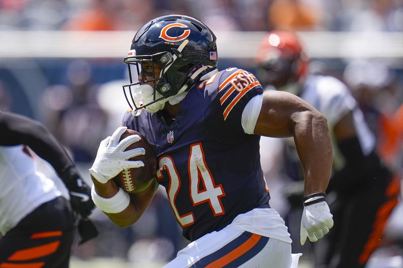 Chicago Bears running back Khalil Herbert (24) runs with the ball during the first half of an NFL preseason football game against the Cincinnati Bengals, Saturday, Aug. 17, 2024, at Soldier Field in Chicago. (AP Photo/Erin Hooley)