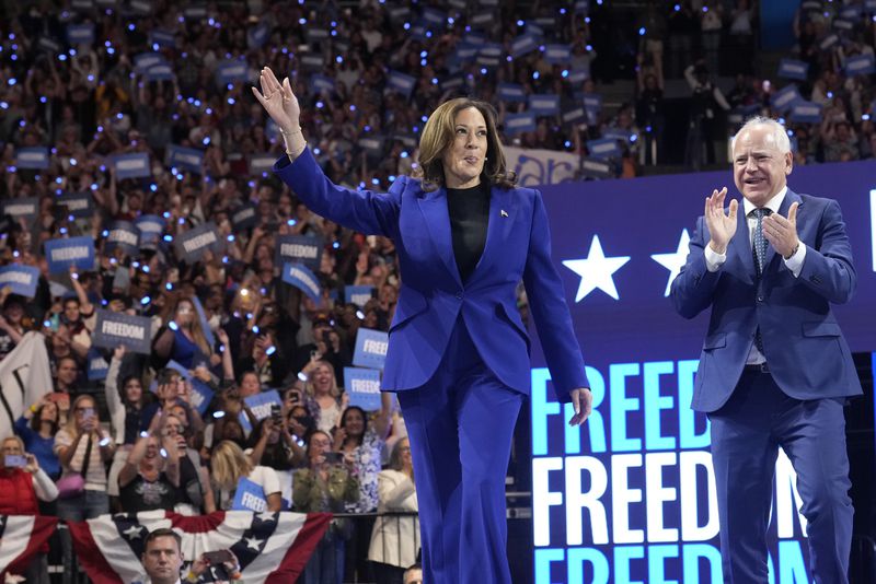 Democratic presidential nominee Vice President Kamala Harris arrives with running mate Minnesota Gov. Tim Walz at the Fiserv Forum during a campaign rally in Milwaukee, Tuesday, Aug. 20, 2024. (AP Photo/Jacquelyn Martin)