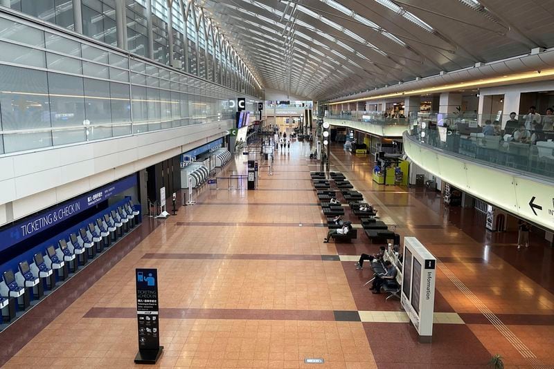 A terminal is empty as flights were canceled due to an approaching typhoon at Haneda airport in Tokyo Friday, Aug. 16, 2024. (Kyodo News via AP)