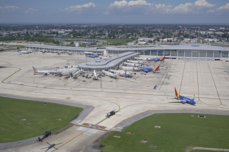 A pair of helicopters land at New Orleans International Airport following Hurricane Francine, Friday, Sept. 13, 2024, in Kenner, La. (Hilary Scheinuk/The Advocate via AP, Pool)