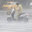 A man struggles in the heavy wind and rain generated by Typhoon Krathon in Kaohsiung, southern Taiwan, Thursday, Oct. 3, 2024. (AP Photo/Chiang Ying-ying)