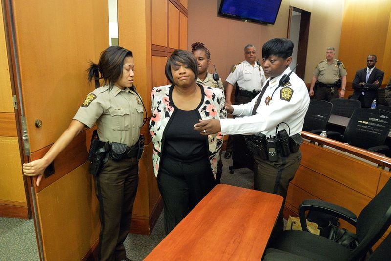 Former Atlanta Public Schools School Reform Team Director Tamara Cotman is led to a holding cell after a jury convicted her of a racketeering charge on April 1, 2015. Public-records requests uncovered information showing educators engaged in a conspiracy to inflate test scores. (AJC FILE PHOTO)