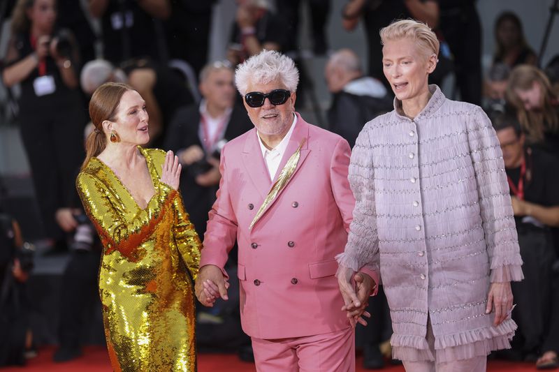 Julianne Moore, from left, director Pedro Almodovar, and Tilda Swinton pose for photographers upon arrival for the premiere of the film 'The Room Next Door' during the 81st edition of the Venice Film Festival in Venice, Italy, on Monday, Sept. 2, 2024. (Photo by Vianney Le Caer/Invision/AP)