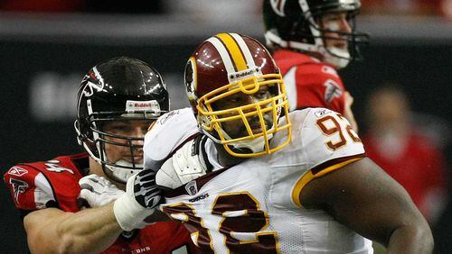 Albert Haynesworth (white jersey) is blocked by Falcons lineman  Will Svitek in a Nov. 8, 2009 game. Curtis Compton, ccompton@ajc.com