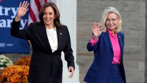 Democratic presidential nominee Vice President Kamala Harris walks with former Rep. Liz Cheney, R-Wyo., at a campaign rally at Ripon College, Thursday, Oct. 3, 2024, in Ripon, Wis. (AP Photo/Charlie Neibergall)