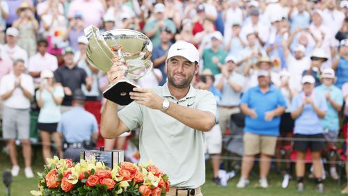 Scottie Scheffle celebrates with the FedEx Cup trophy after winning the Tour Championship at East Lake Golf Club, Sunday, Sept. 1, 2023, in Atlanta. 
(Miguel Martinez / AJC)