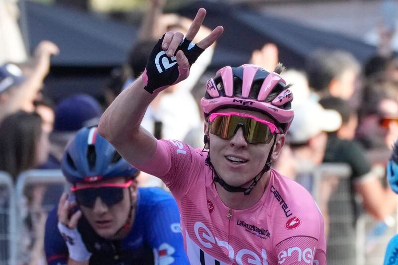 Slovenia's Tadej Pogacar, wearing the pink jersey overall leader, flashes the victory sign after crossing the finish line of the 21st and last stage of the Giro D'Italia, tour of Italy cycling race, in Rome, Sunday, May 26, 2024. (AP Photo/Andrew Medichini)