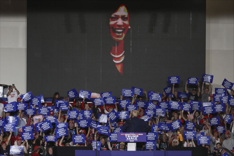 Republican presidential nominee former President Donald Trump turns to watch a video on the screen as speaks at a campaign rally at Bayfront Convention Center in Erie, Pa., Sunday, Sept. 29, 2024. (AP Photo/Rebecca Droke)