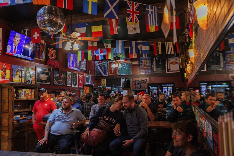 San Francisco Republican party members watch a presidential debate between Democratic presidential nominee Vice President Kamala Harris and Republican presidential nominee former President Donald Trump at Mad Dog In The Fog on Tuesday, Sept. 10, 2024, in San Francisco. (AP Photo/Juliana Yamada)