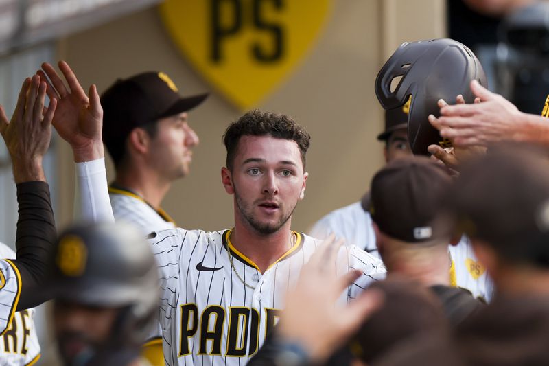 San Diego Padres' Jackson Merrill celebrates in the dugout after scoring off a two-run home run hit by Xander Bogaerts during the second inning of a baseball game against the Chicago White Sox, Saturday, Sept. 21, 2024, in San Diego. (AP Photo/Ryan Sun)