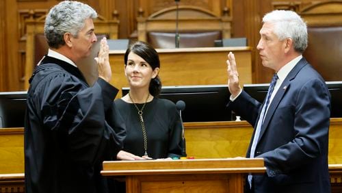 The Honorable David H. Nahmias (right) administers the Oath of Office to Michael Boggs as his wife Heather Boggs holds the bible during the sworn-in ceremony as the state’s new chief justice at State Capitol on Monday, July 18, 2022. Miguel Martinez /miguelmartinezjimenezajc.com