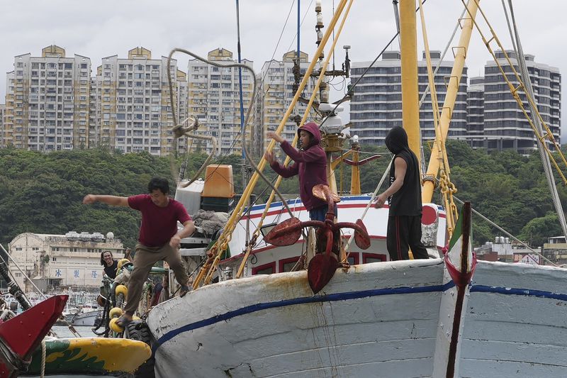 Workers tighten boats with ropes before Typhoon Krathon arrives, at a harbor in Keelung, Taiwan, Monday, Sept. 30, 2024. (AP Photo/Johnson Lai)