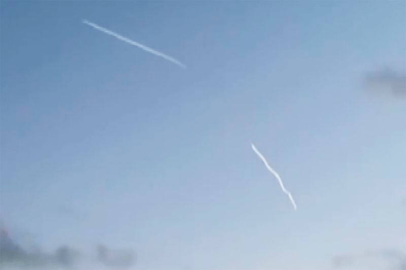 In this photo taken from video provided by Adar E Goldenberg, traces of presumably an attacking missile, right, and air defense missile, left, are seen in the air in Tel Aviv, Israel, Wednesday, Sept. 25, 2024. Hezbollah hurled dozens of projectiles into Israel early Wednesday, including a missile aimed at Tel Aviv that was the militant group's deepest strike yet and marked a further escalation after Israeli strikes on Lebanon killed hundreds of people. (Adar E Goldenberg via AP)