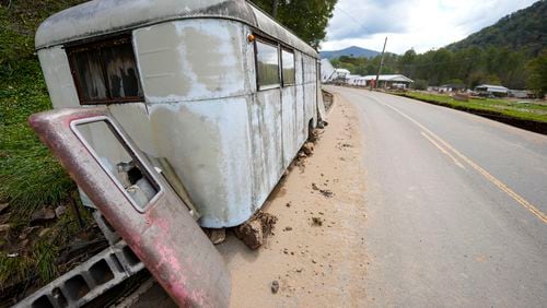 A trailer moved by floodwater sits on the side of a road in the aftermath of Hurricane Helene, Thursday, Oct. 3, 2024, in Pensacola, N.C. (AP Photo/Mike Stewart)