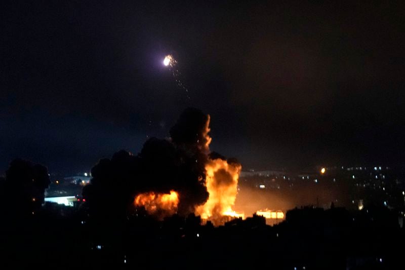 Flames rise from Israeli airstrikes in Dahiyeh, Beirut, Lebanon, Friday, Oct. 4, 2024. (AP Photo/Hussein Malla)