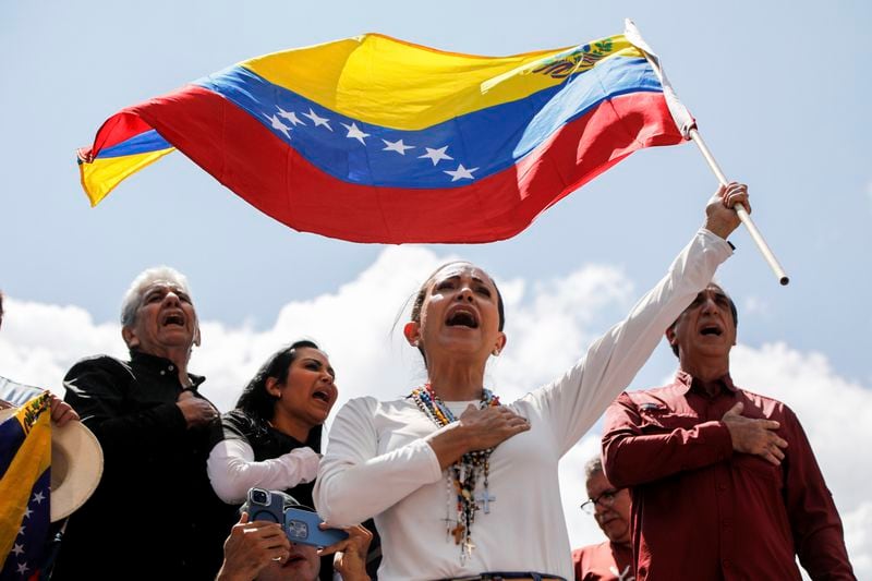 Opposition leader Maria Corina Machado waves a Venezuelan national flag during a rally to protest official results that declared President Nicolas Maduro the winner of the July presidential election, in Caracas, Venezuela, Saturday, Aug. 17, 2024. (AP Photo/Ariana Cubillos)