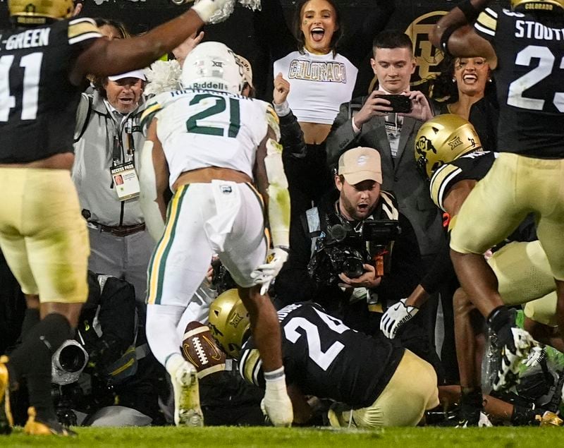 Colorado cornerback Preston Hodge (24) recovers a fumble by Baylor running back Dominic Richardson (21) in the end zone to secure Colorado's overtime victory in an NCAA college football game Saturday, Sept. 21, 2024, in Boulder, Colo. (AP Photo/David Zalubowski)