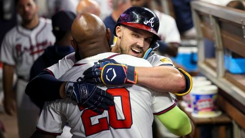 Atlanta Braves left fielder Adam Duvall, facing, hugs designated hitter Marcell Ozuna (20) after Duvall hit a solo home run during the sixth inning against the Philadelphia Phillies at Truist Park, Thursday, August 22, 2024, in Atlanta. The Braves won 3-2 and won the series 2-1. (Jason Getz / AJC)
