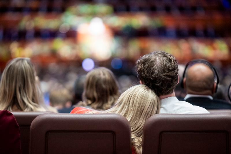 Conferencegoers rest their heads on each other as they listen to Elder Neil L. Andersen, of the Quorum of the Twelve Apostles, speak during the morning session of the 194th Semiannual General Conference of The Church of Jesus Christ of Latter-day Saints held at the Conference Center in Salt Lake City on Saturday, Oct. 5, 2024. (Isaac Hale/The Deseret News via AP)