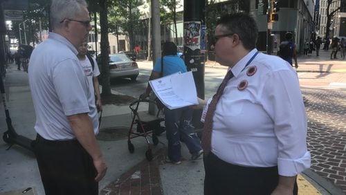 Georgia State University employee Deb Loden talks to another employee about a proposal by United Campus Workers of Georgia to demand the University System of Georgia stop its plan to increase employee health care costs next year. Loden, who's worked nearly 12 years at the university, said the cost increases are more than her raises. "It's going to get to a point where I can't work here anymore," Loden said. ERIC STIRGUS/ESTIRGUS@AJC.COM.