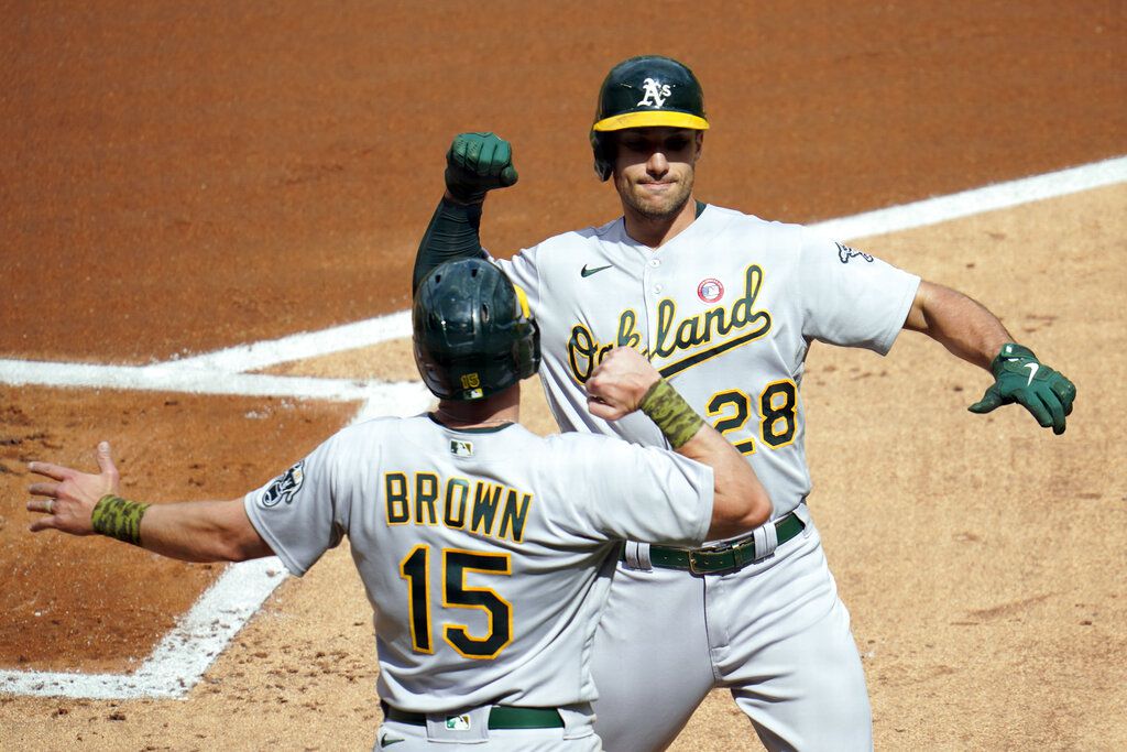 Matt Olson of the Oakland Athletics swings and watches the flight of