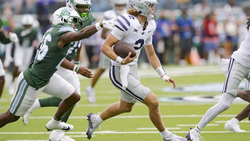 Kansas State quarterback Avery Johnson (2) runs as Tulane safety Shi'Keem Laister (26) closes in during the first half of an NCAA college football game in New Orleans, Saturday, Sept. 7, 2024. (AP Photo/Matthew Hinton)