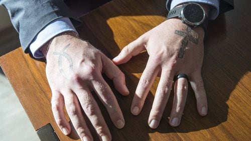 Michael Yandell, pastoral consultant with the Emory Healthcare Veterans Program, shows his tattoos in the Emory Healthcare Veterans Program suite at the Emory Health Brain Center in Atlanta, Wednesday, December 18, 2019. (ALYSSA POINTER/ALYSSA.POINTER@AJC.COM)