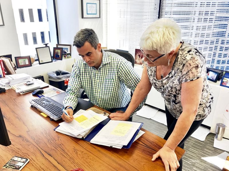 Josh Moffitt, founder of the nonprofit Silverton Foundation, looks over applications with his mother, Sam Silver Moffitt. The foundation provides rent and mortgage assistance to families of sick children. CONTRIBUTED