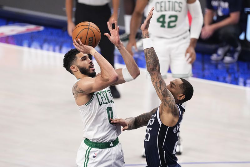 Boston Celtics forward Jayson Tatum (0) shoots over Dallas Mavericks forward P.J. Washington (25) during the first half in Game 4 of the NBA basketball finals, Friday, June 14, 2024, in Dallas. (AP Photo/Sam Hodde)