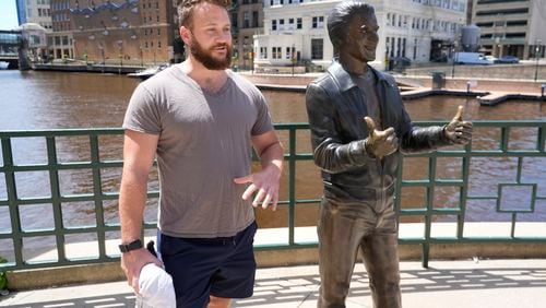 Jake Schneider talks about the Republican National Convention coming to Milwaukee next to the bronze Fonz statue Monday, July 1, 2024, in Milwaukee. (AP Photo/Morry Gash)