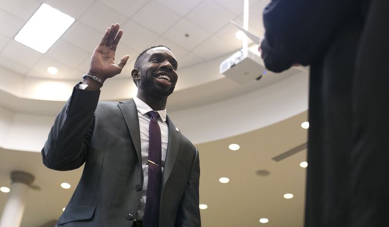 Everton Blair takes an oath during his swearing-in ceremony at the Gwinnett County Board of Education office in Suwanee, Ga., on Thursday, Dec. 20, 2018. (Casey Sykes for The Atlanta Journal-Constitution)