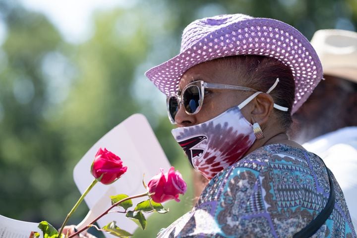 Daisy P. Belt holds two roses while attending a Juneteenth celebration at the Pierce Chapel African Cemetery in Midland, outside of Columbus, on Monday, June 20, 2022. The cemetery was rediscovered in 2019 and work has since been done to clean, document and preserve it. Ben Gray for the Atlanta Journal-Constitution