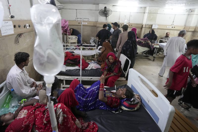 Patients of heatstroke receive treatment at a hospital in Karachi, Pakistan, Tuesday, June 25, 2024. Various parts of the country continued to experience an intense heat wave conditions, with the temperatures reaching 47 degree Celsius (116.6 Fahrenheit) in Nawabshah and other cities, according to the press release of the Pakistan Meteorological Department. (AP Photo/Fareed Khan)