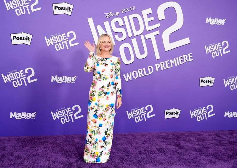 Amy Poehler, a cast member in "Inside Out 2," waves to photographers at the premiere of the film at the El Capitan Theatre, Monday, June 10, 2024, in Los Angeles. (AP Photo/Chris Pizzello)