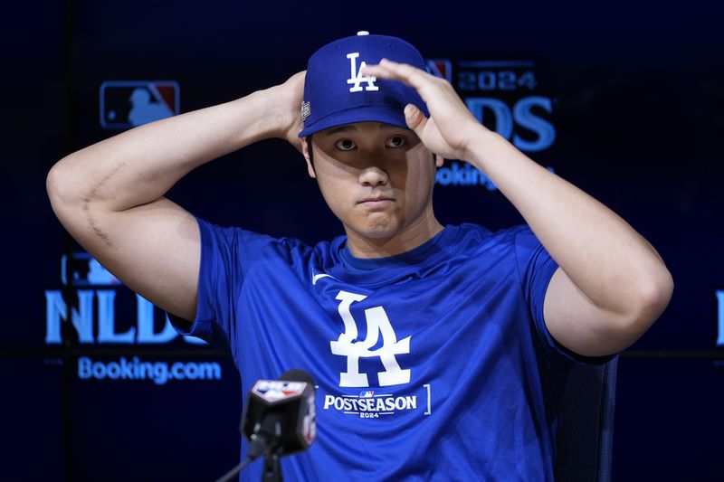 Los Angeles Dodgers' Shohei Ohtani speaks to reporters in a press conference in preparation for Game 1 of a baseball NL Division Series against the San Diego Padres in Los Angeles, Friday, Oct. 4, 2024. (AP Photo/Ashley Landis)