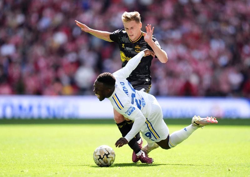 Leeds United's Wilfried Gnonto, right, and Southampton's Flynn Downes battle for the ball during the Championship play-off final between Leeds United and Southampton at Wembley Stadium, London, Sunday May 26, 2024. (John Walton/PA via AP)