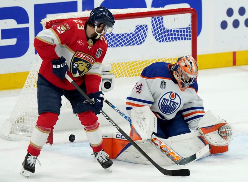 Florida Panthers forward Carter Verhaeghe (23) scores on Edmonton Oilers goaltender Stuart Skinner (74) during the first period of Game 7 of the NHL hockey Stanley Cup Final on Monday, June 24, 2024, in Sunrise, Fla. (Nathan Denette/The Canadian Press via AP)