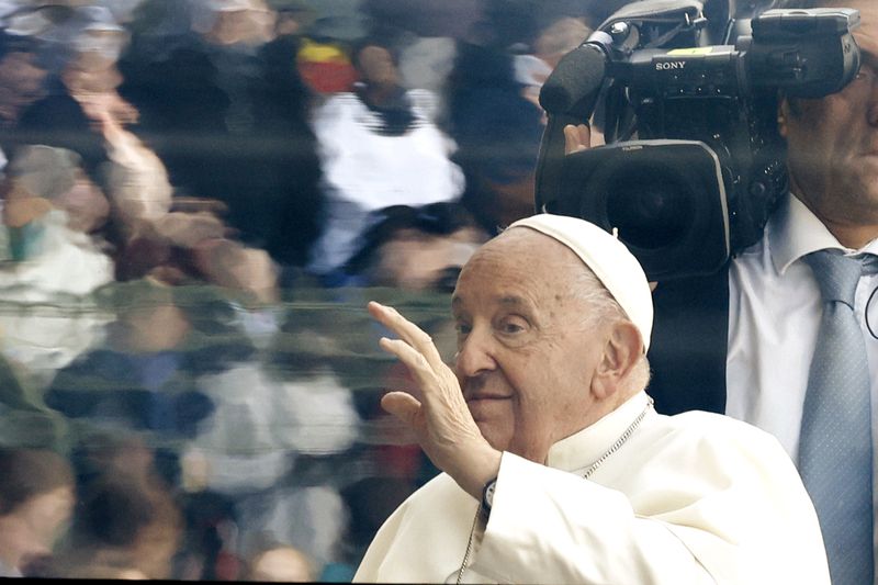 Pope Francis waves as he arrives to lead the holy mass , at the King Baudouin stadium in Brussels, Belgium, Sunday, Sept. 29, 2024. (AP Photo/Omar Havana)