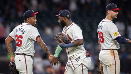 Braves pitcher Raisel Iglesias (26), outfielder Michael Harris II (23), and first baseman Matt Olson (28) celebrate after a win over the Rockies at Truist Park on Wednesday, Sept. 4, 2024. (Arvin Temkar / AJC)